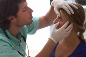 doctor examining patient's eyes
