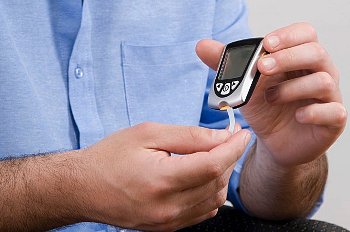 Person checks glucose levels on a glucose meter