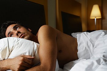 Man lays in bed awake