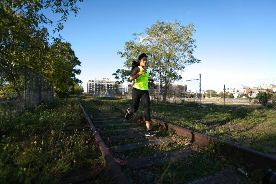 Lucero Rodriguez runs on train tracks