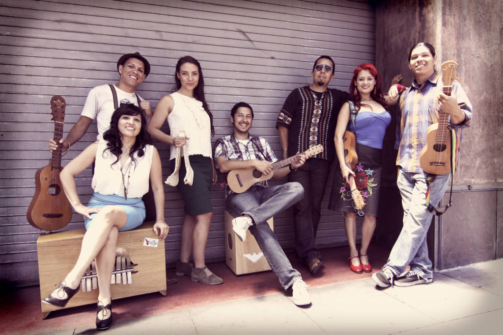 Las Cafeteras sit outside in an urban setting. Photo by Piero F. Giunti