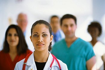 Doctor stands with team behind her