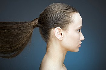 Girl facing right with long ponytail behind her
