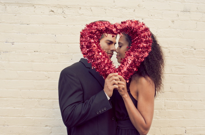 A couple holding a shiny streamer heart