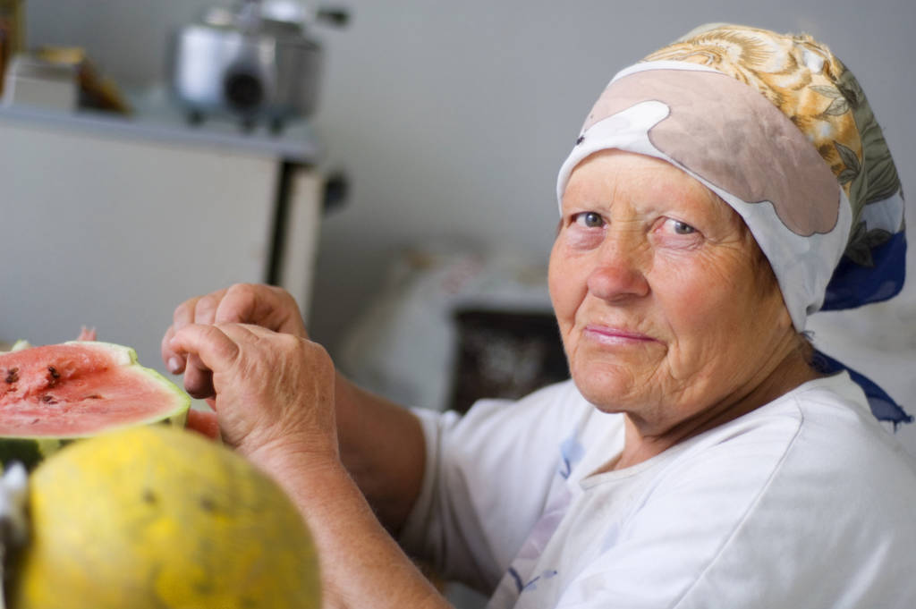 old woman eating a watermelon