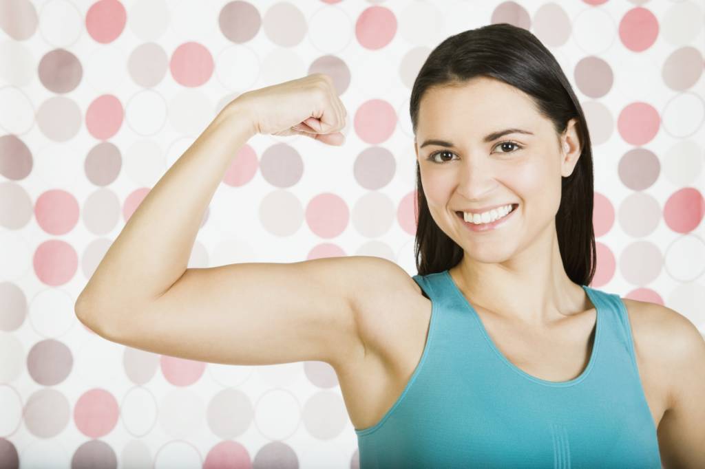 Woman flexing her bicep, woman with toned arms