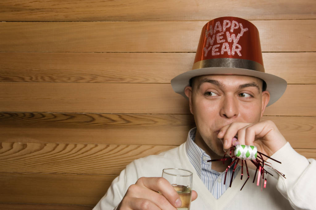 man wearing happy new year hat, man celebrating, new year image