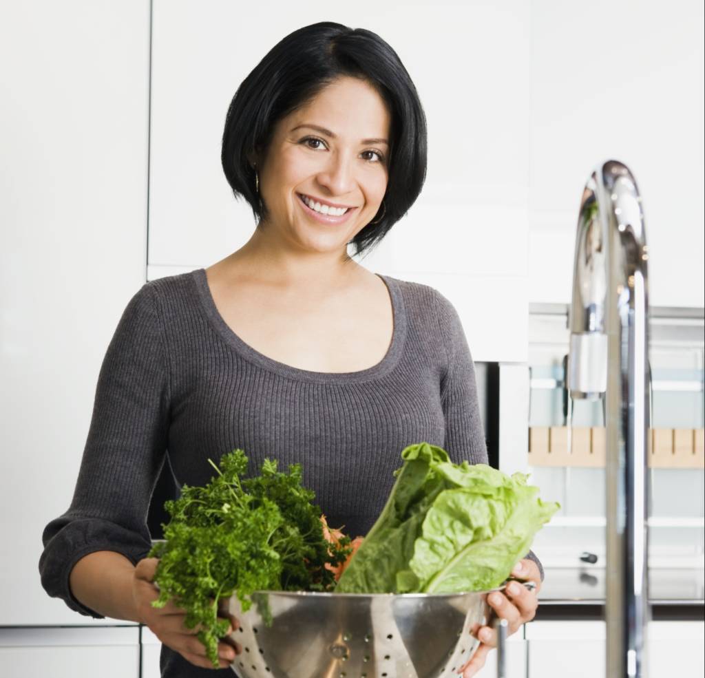 woman washing vegetables, green vegetables