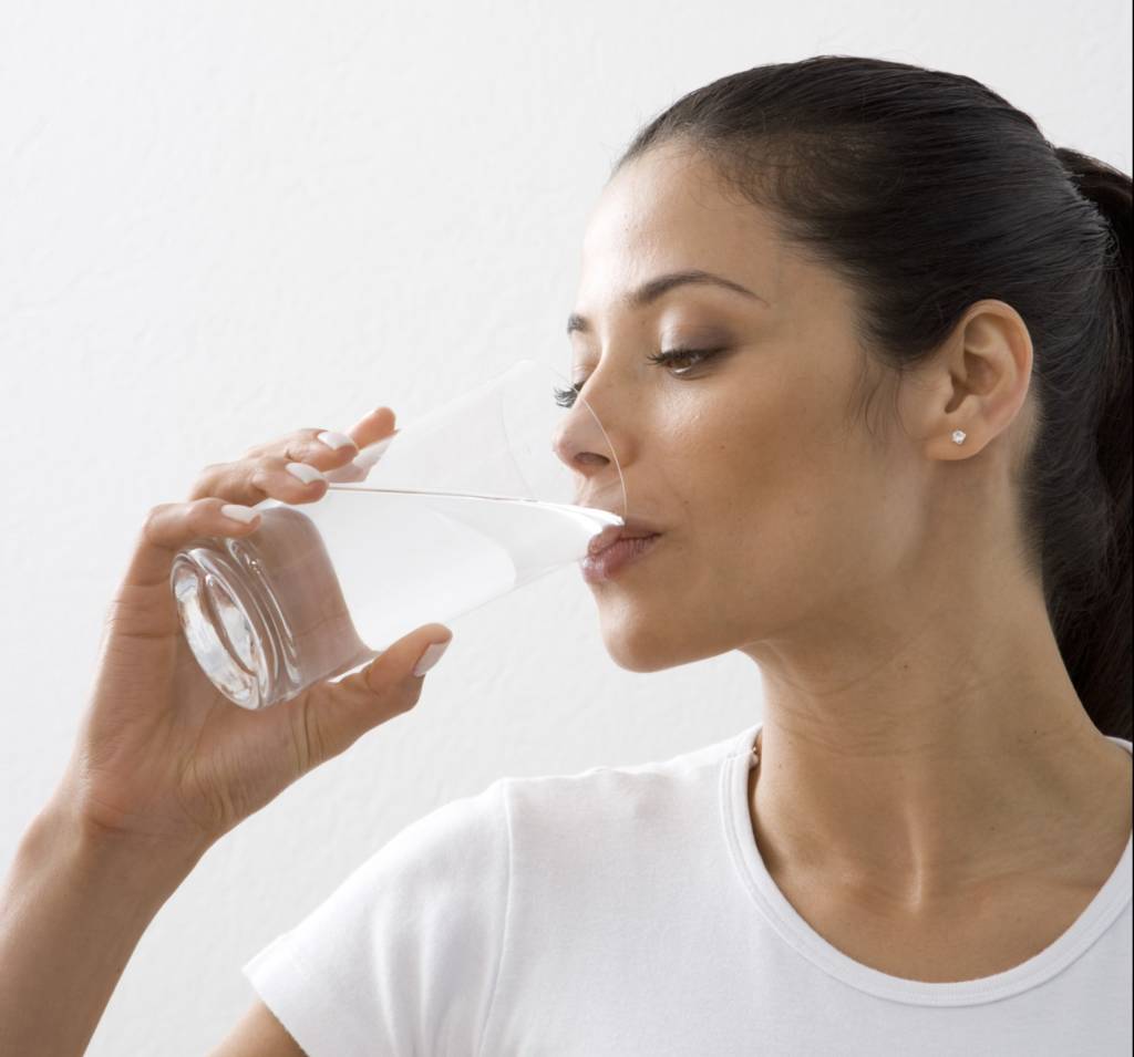 hispanic woman drinking water