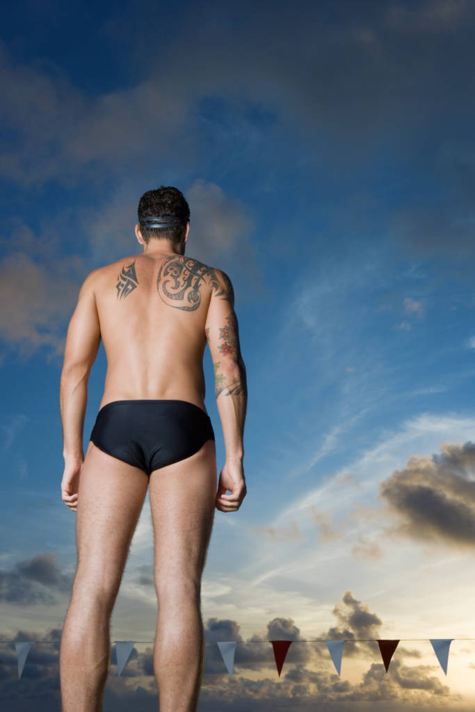 male swimmer with tattoo