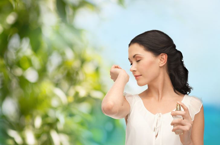 woman smelling her wrist