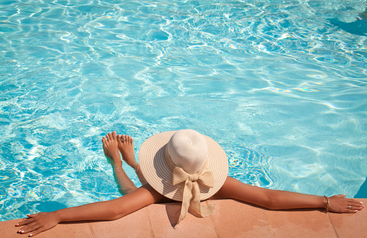 woman in the pool with a hat