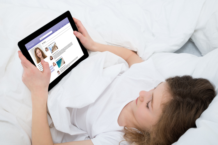 girl in bed with ipad